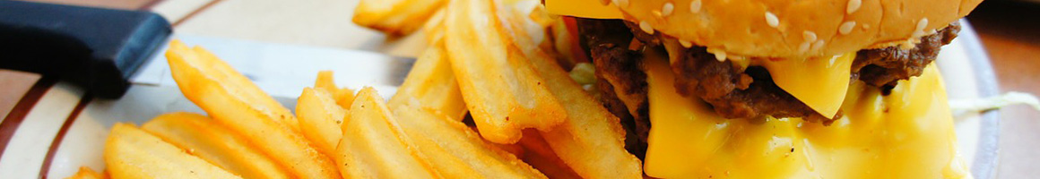 Eating Burger at Roy's All Steak Hamburgers restaurant in Auburn, ME.